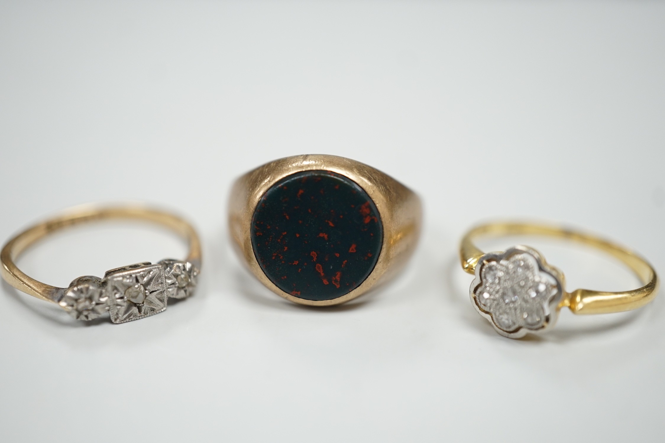A 1920's 18ct and diamond chip set cluster ring, size N, gross 2.4 grams and two 9ct rings including bloodstone set signet, gross 7.2 grams.